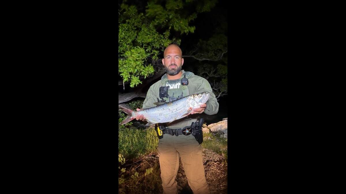 Monroe County Sheriff’s Office Deputy Luis Guiardinu and the dead tarpon Monroe County Sheriff’s Office Deputy Luis Guiardinu and the dead tarpon